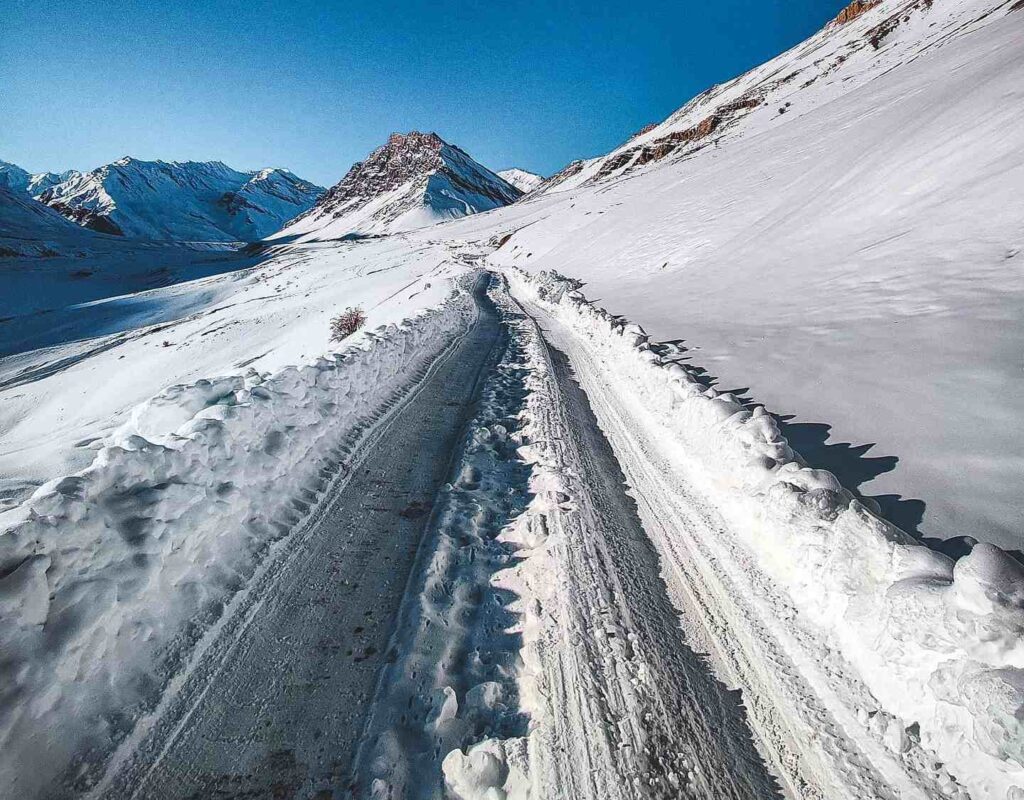 High-altitude winter adventure in Spiti Valley with snow and Himalayan peaks
