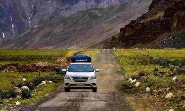 Manali to Leh Ladakh Kargil Adventure Tour, scenic Himalayan landscape with high mountain passes, winding roads, rugged valleys and snow-covered peaks showcasing the ultimate adventure route in India.