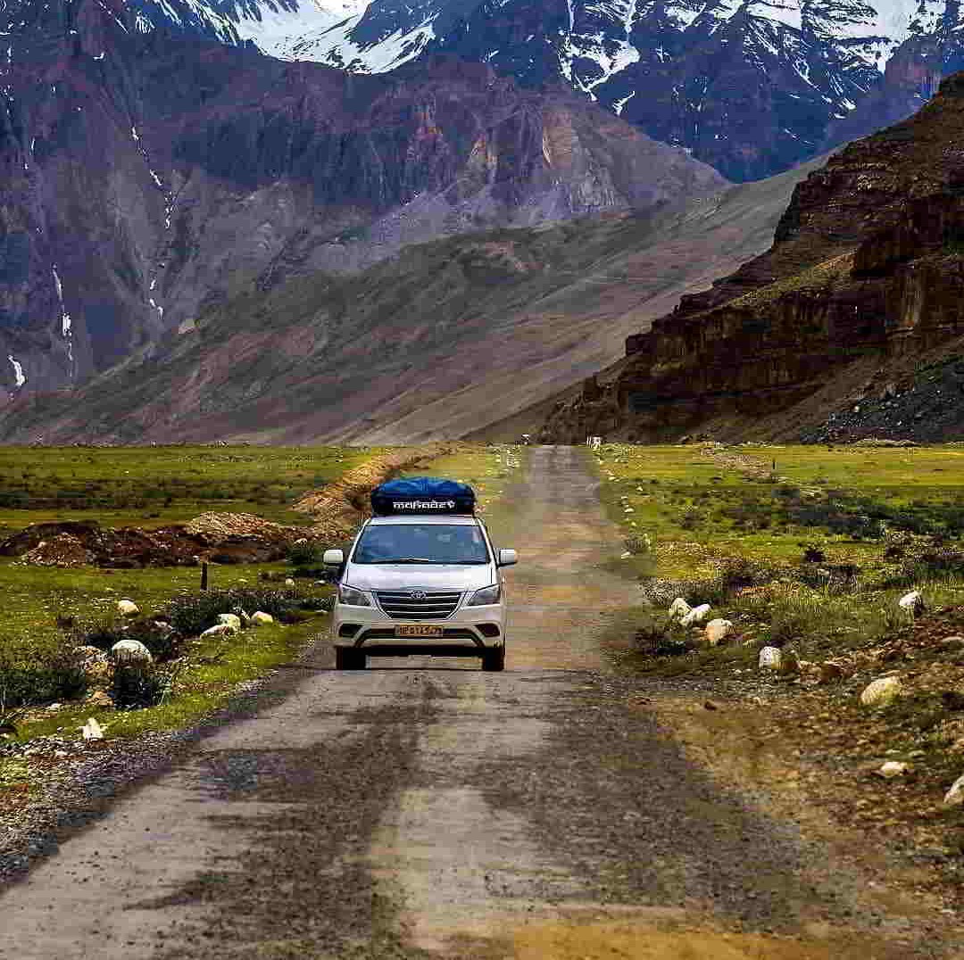 Manali to Leh Ladakh Kargil Adventure Tour, scenic Himalayan landscape with high mountain passes, winding roads, rugged valleys and snow-covered peaks showcasing the ultimate adventure route in India.