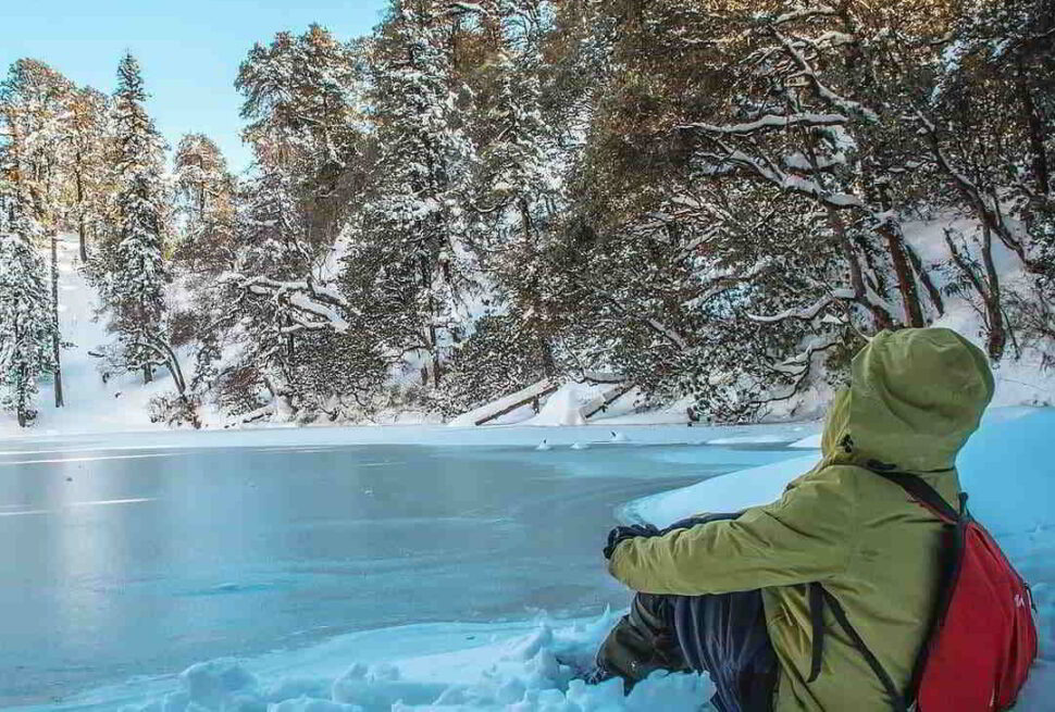 Brahmatal Trek trail with snow covered Himalayan peaks and alpine landscape.